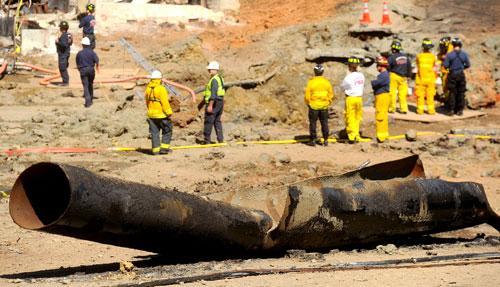 A natural gas line, the cause of the large explosion that killed at least seven people, lies broken on a San Bruno, Calif., road, Sept. 11, 2010. (AP)
