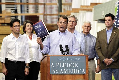 House Minority Leader John Boehner of Ohio, center, surrounded by fellow GOP Congress members, holds up a copy of the new GOP agenda, &quot;A Pledge to America&quot;, Sept. 23, 2010. (AP)
