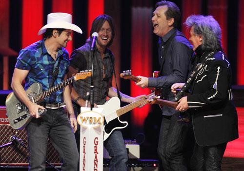 Brad Paisley, Keith Urban, Steve Wariner and Marty Stuart, from left, in the Grand Ole Opry House on Sept. 28, 2010, in Nashville, Tenn. The performance is the first session held in the Opry House since it was damaged by floodwaters in May. (AP) 