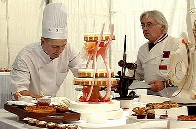 Chef Jacquy Pfeiffer sets up his buffet for the final Meilleurs Ouvriers de France judging, while a MOF judge looks on. (D.A. Pennebaker)
