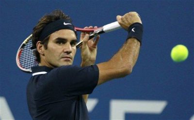 Roger Federer returns a shot to Robin Soderling during a quarterfinal match at the U.S. Open tennis tournament in New York, Wednesday, Sept. 8, 2010.(AP Photo/Charles Krupa)