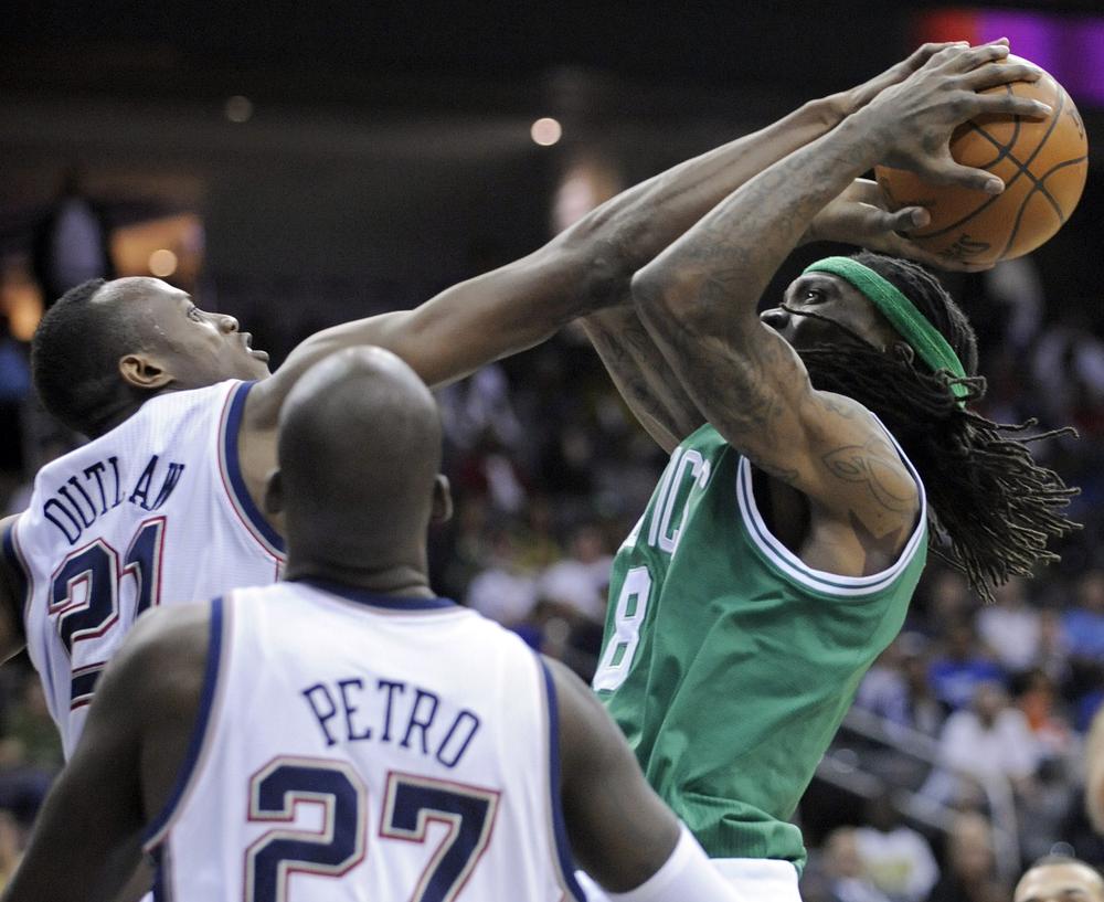 New Jersey Nets forward Travis Outlaw, left, blocks a shot attempt by Boston Celtics guard Marquis Daniels, right, as Nets Johan Petro looks on during the third quarter of a preseason NBA basketball game on Thursday in Newark, N. J. The Celtics won 96-92. (AP)