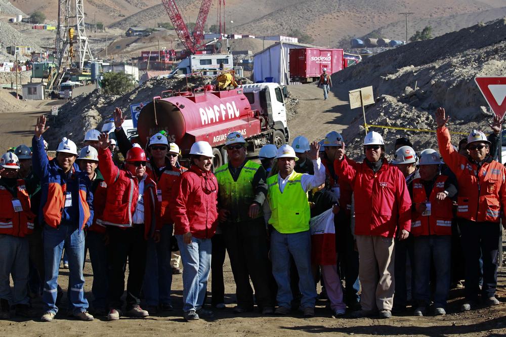 Chilean mining officials and personnel involved in the rescue operation of 33 trapped miners wave as they celebrate at  the San Jose Mine near Copiapo, Chile Saturday.  (AP Photo/Dario Lopez-Mills)