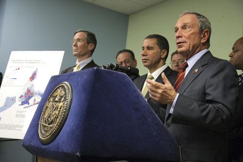 New York City Mayor Michael Bloomberg, right, and NY Gov. David Paterson, center, unveil an initiative excluding soda from food stamp purchases, Oct. 7, 2010 (AP)