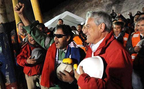 The last miner to be rescued, Luis Urzua, center, with Chile&#039;s President Sebastian Pinera, right, at the collapsed San Jose mine. (AP)