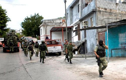 Soldiers patrol a neighborhood after a shoot out between rival gangs in Monterrey, Mexico, Oct. 5, 2010. (AP)