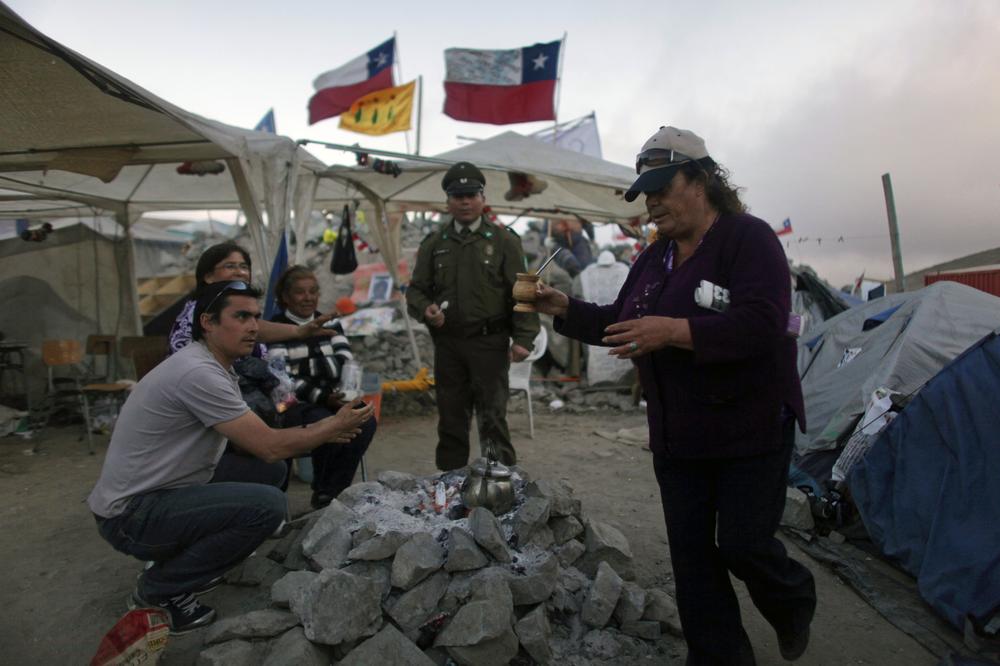 Relatives of trapped miners gather around a fire at the San Jose mine near Copiapo, Chile, Saturday.  (AP Photo/Dario Lopez-Mills)