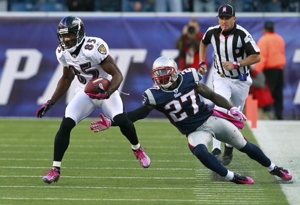 Baltimore wide receiver Derrick Mason (85) evades New England cornerback Kyle Arrington (27) in overtime during the game on Sunday in Foxborough, Mass. The Patriots won 23-20. (AP)