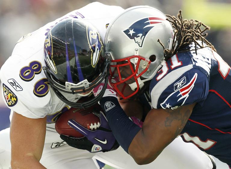 Baltimore Ravens tight end Todd Heap, left, takes a hit from New England Patriots safety Brandon Meriweather, during a game on Oct. 17. (AP)
