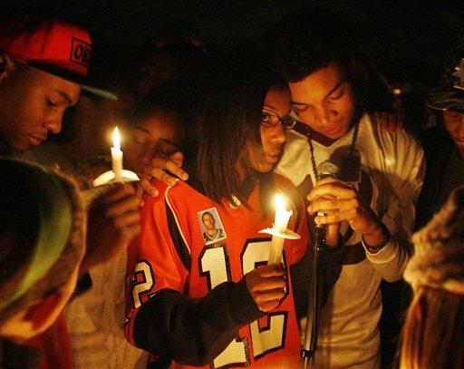 Kyle Henry, right, and his sister Amber, center, siblings of Danroy Henry, Jr., speak at a vigil for Danroy, Monday in Easton, Mass. (AP)