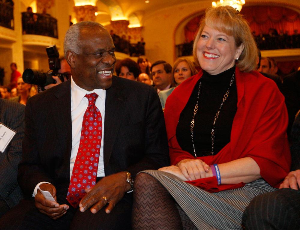 In this Nov. 15, 2007, file photo, Supreme Court Justice Clarence Thomas sits with his wife, Virginia Thomas, as he is introduced at the Federalist Society in Washington. (Charles Dharapak/AP)
