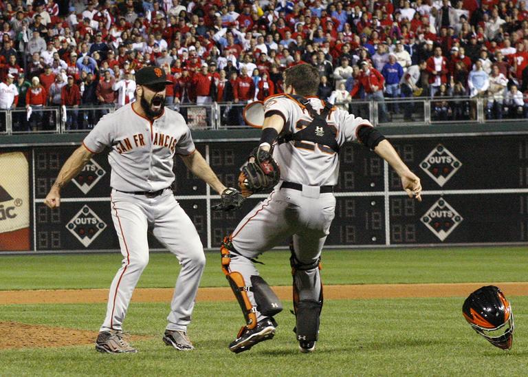 San Francisco Giants relief pitcher Brian Wilson celebrates with catcher Buster Posey after leading his team to a defeat of the Philadelphia Phillies, and a World Series berth. (AP)