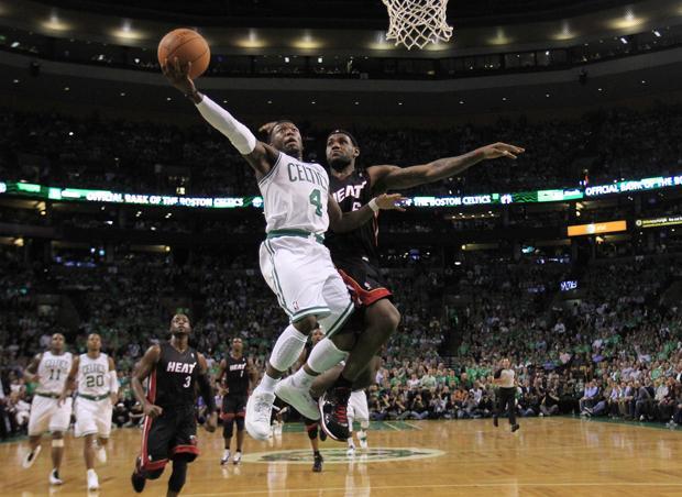Boston guard Nate Robinson drives to the basket past Miami forward LeBron James during the first half of the game in Boston on Tuesday. (AP)