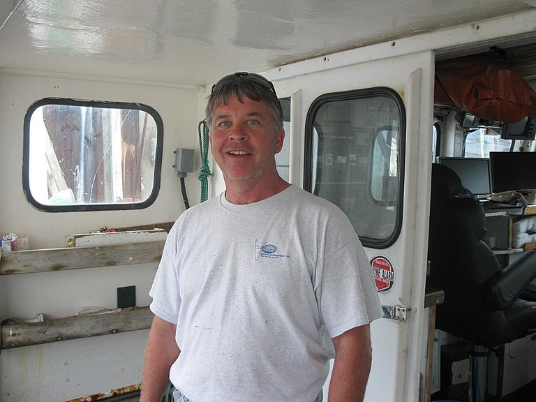 Steve Welch, a commercial fisherman, aboard his boat in Scituate Harbor (Fred Thys/WBUR)
