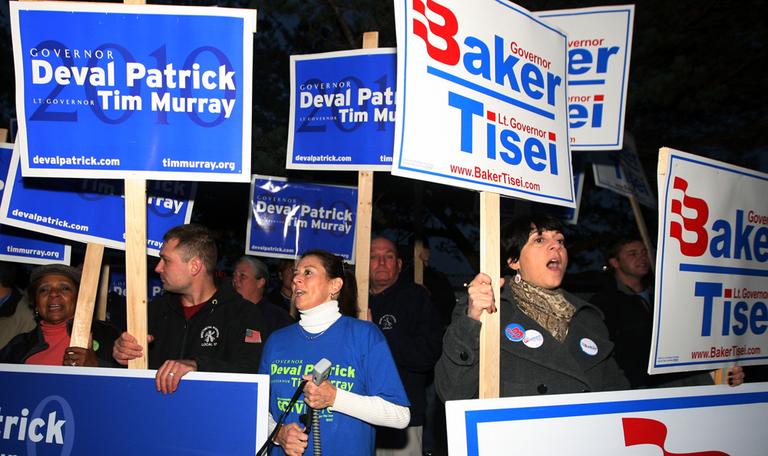 Supporters of incumbent Democratic Gov. Deval Patrick, left, and Republican gubernatorial candidate Charles D. Baker shout slogans outside a gubernatorial debate, Monday, Oct. 25, 2010. (AP)