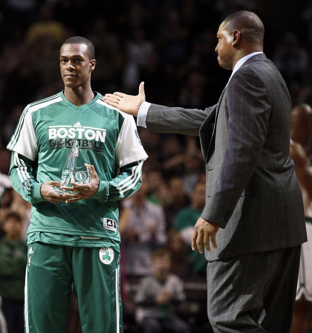 Boston Celtics head coach Doc Rivers, right, presents point guard Rajon Rondo with awards for leading the league in steals and being named to the all-defensive team last season prior to their 105-101 win against the New York Knicks. (AP Photo/Winslow Townson)