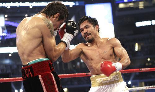 Manny Pacquiao, right, lands a blow against Antonio Margarito, on his way to victory in their title boxing match, Nov. 13, 2010, in Texas. (AP)
