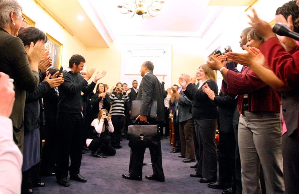 Gov. Deval Patrick's staff applauded as he entered his State House office on Wednesday. (Bizuayehu Tesfaye/AP)