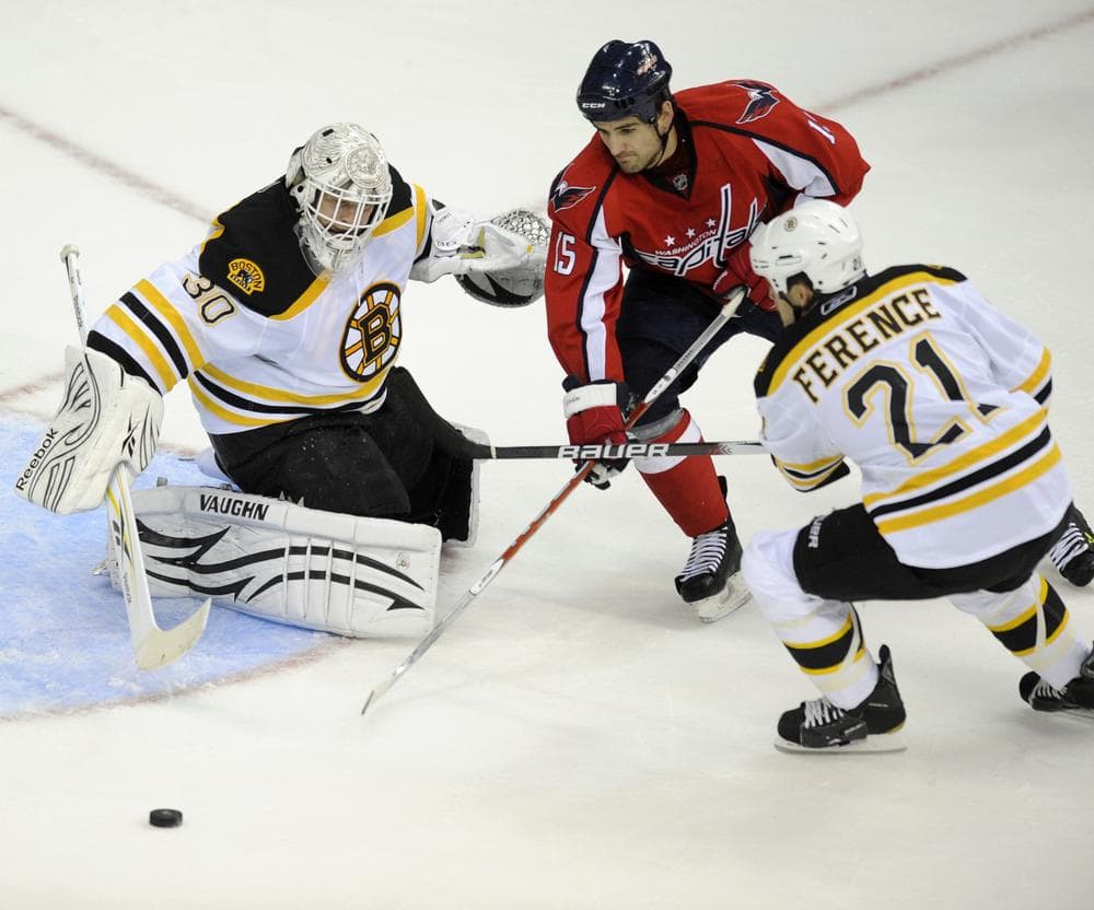 Capitals right wing Boyd Gordon (15) battles for the puck against Bruins goalie Tim Thomas, left, and defenseman Andrew Ference, right, during the first period , Friday, in Washington. (AP Photo/Nick Wass)