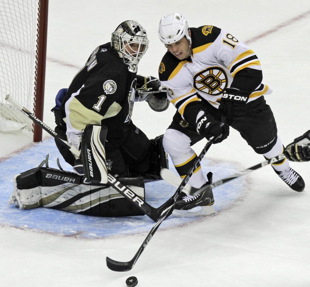 Boston's Nathan Horton can't get a shot off in front of Pittsburgh goalie Brent Johnson (1) during the first period of the game in Pittsburgh on Wednesday. The Bruins won 7-4. (AP)