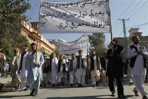 Supporters of former legislators carry banners calling for the Afghan government to clamp down on fraud as they protest against the recent parliamentary elections, in Jalalabad, east of Kabul, Afghanistan. (AP)