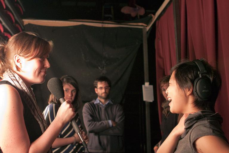 Performer Caitlin Schwager, left, at a &quot;Mortified&quot; event in Boston, with On Point producer Pien Huang, far right, Nov. 5, 2010. (Mackenzie Knowles-Coursin for WBUR)