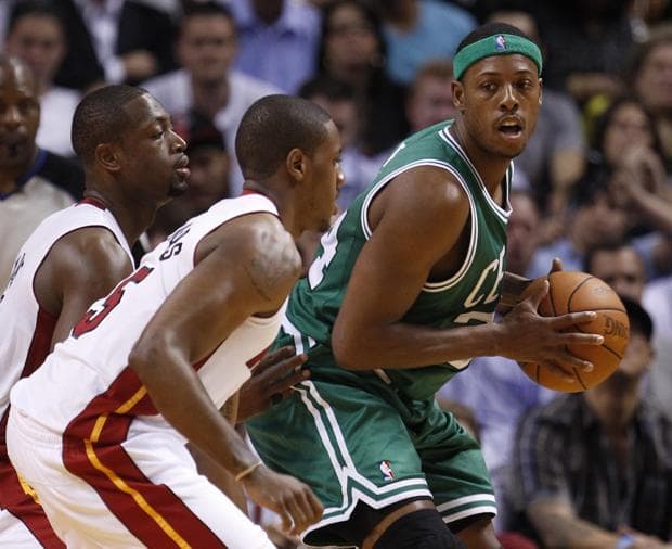 Boston forward Paul Pierce, right, looks for an opening past Miami shooting guard Dwyane Wade, left, and shooting guard Jerry Stackhouse during the first half of the game on Thursday in Miami. (AP)