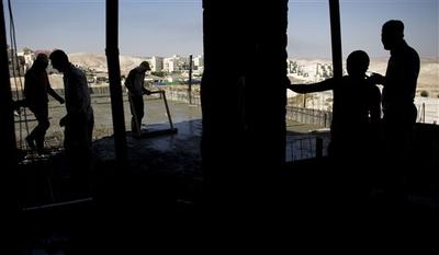 Palestinian men work on a construction site in the West Bank Jewish settlement of Maale Adumim, near Jerusalem. (AP)