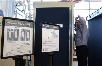 Transportation Security Administration manager Anthony Crimi demonstrates how a new full-body imaging machine will be used at one of the security checkpoints inside Lambert- St. Louis International Airport.  (AP)