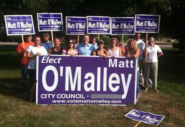 Matt O'Malley, center in blue, on a campaign stop in July, 2010. (Courtesy Matt O'Malley campaign)