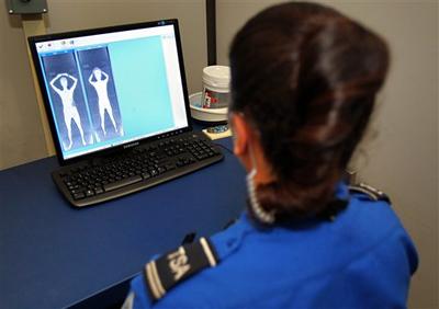 A Transportation and Safety Administration agent views body images from the new Rapid Scan 1000 body scanning machine at Sky Harbor International Airport in Phoenix. (AP)