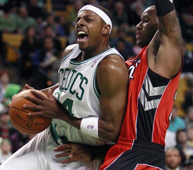 Boston's Paul Pierce, left, drives past Toronto's Sonny Weems in the first quarter of a game on Oct. 10, 2010, in Boston. (AP)
