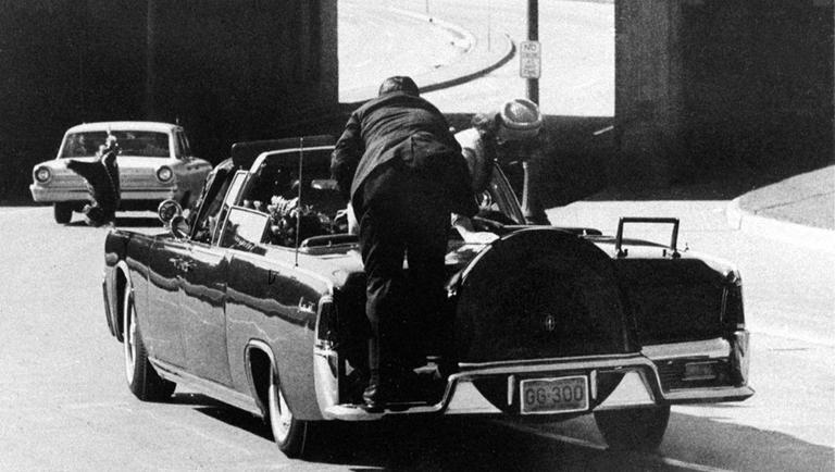 Secret Service agent Clint Hill jumps on the back of the Kennedy motorcade after President John F. Kennedy was shot in Dallas on Nov. 22, 1963. (AP)