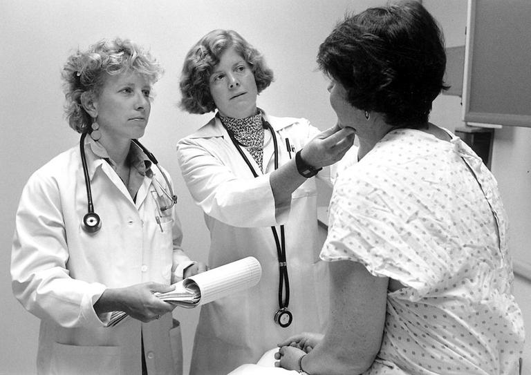 Doctors examine a patient. (Seattle Municipal Archives)