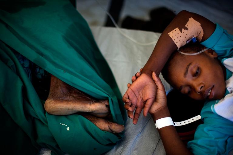 A Haitian boy suffering cholera symptoms receives treatment at a temporary hospital in Port-au-Prince.  (AP)