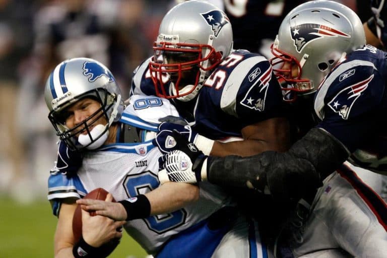 Detroit Lions quarterback Jon Kitna, left, is sacked by New England Patriots' Rosevelt Colvin, center, and Richard Seymour.  The Patriots play the Lions on Thanksgiving, Thursday. (AP Photo/Winslow Townson)