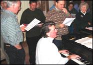 Members of the Boston Minstrel Company gather around a piano. (Courtesy)