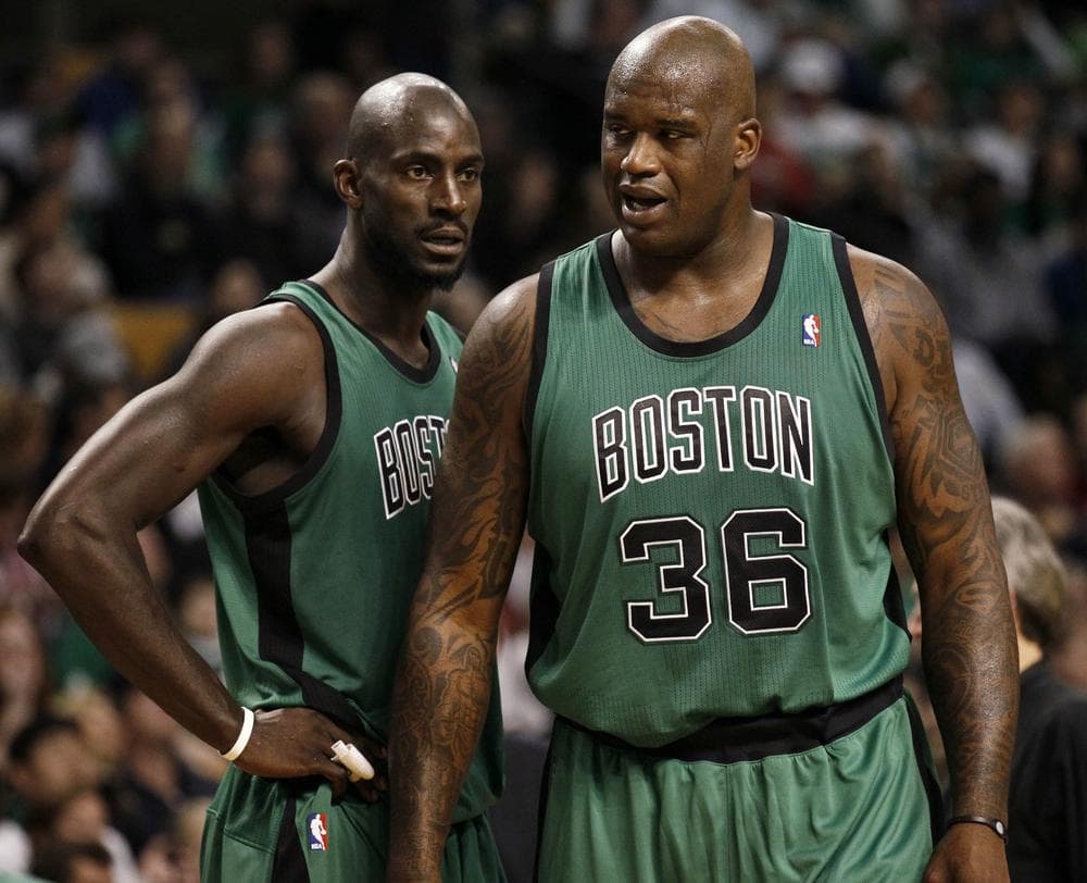 Shaquille O'Neal (36) talks with teammate Kevin Garnett during the second quarter of their win over the Toronto Raptors in Boston. (AP Photo/Winslow Townson)