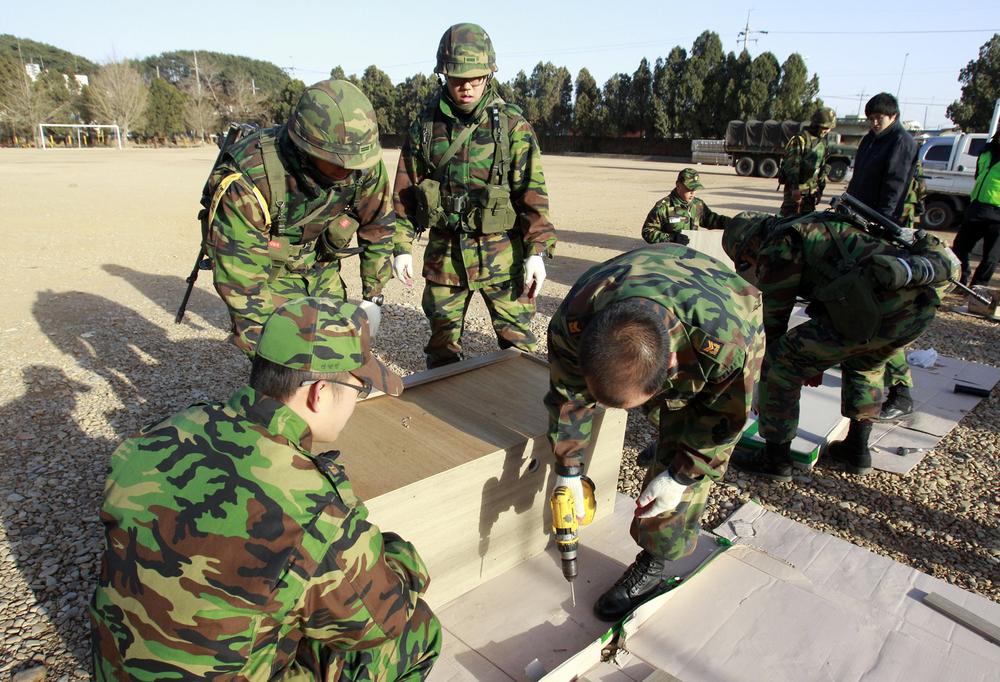 South Korean Marines work to build new houses for villagers on the Yeonpyeong Island, South Korea, Saturday.  (AP Photo/ Lee Jin-man)