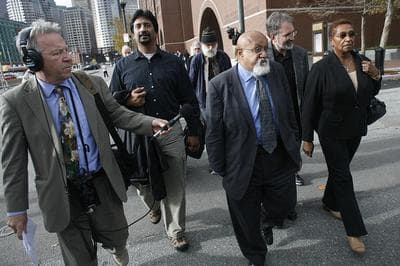 Boston City Councilor Chuck Turner, center, leaves the Moakley Courthouse Oct. 29 after being found guilty on all counts in a corruption trial. (Dominick Reuter for WBUR) 