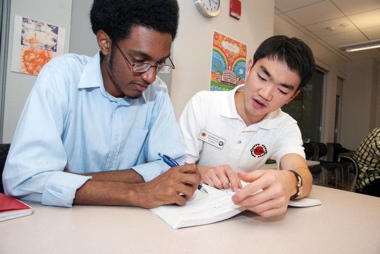 A Boston high-school student working with a City Year counselor (cityyear/Flickr) 