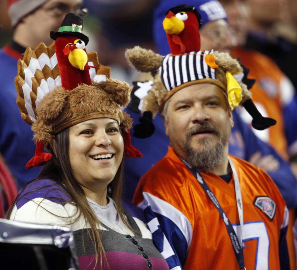 Renata Baca and her husband, Harold, wear turkey hats as they wait for the start of the New York Giants - Denver Broncos game on Nov. 26, 2009. (AP Photo/David Zalubowski)