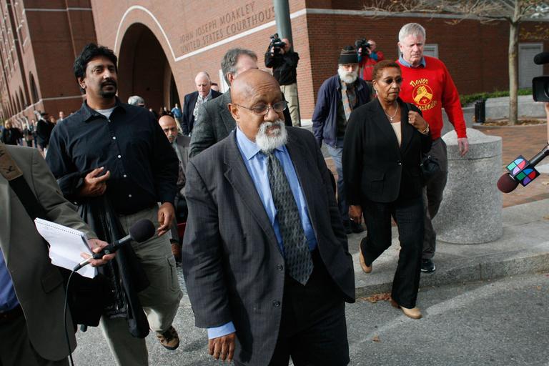 Boston City Councilor Chuck Turner, center, leaves the Moakley Courthouse Oct. 29 after being found guilty on all counts in a corruption trial. (Dominick Reuter for WBUR)
