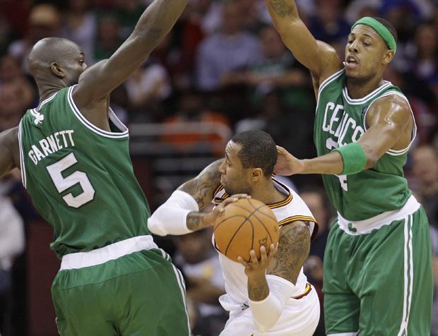 Boston forward Kevin Garnett and Boston forward Paul Pierce put pressure on Cleveland guard Ramon Sessions in the third quarter of the game on Tuesday in Cleveland. (AP)