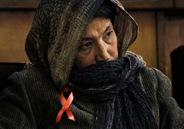 An attendee listens to speeches of the health minister,unseen, in Kabul, Afghanistan on Wednesday. The Afghan ministry of Health estimates there are around 2,000 - 3,000 HIV and AIDS cases all over the country. 