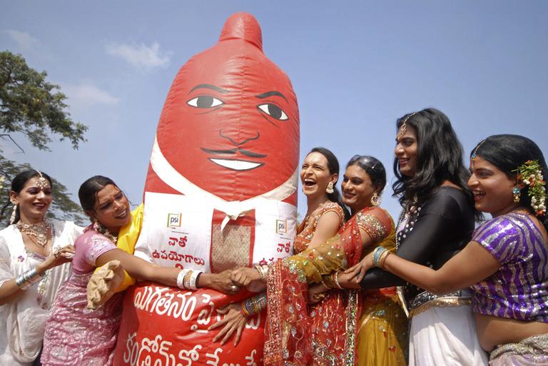 Indian transgenders stand with a giant condom during an awareness rally in Hyderabad, India, Wednesday.