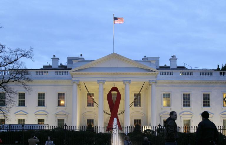A red ribbon hangs from the the North Portico of the White House in Washington, Tuesday, to commemorate World AIDS Day.