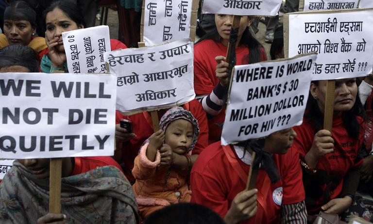 Nepalese HIV-positive people and activists hold placards demanding access to adequate medical services during a rally to in Katmandu, Nepal, Wednesday. 
