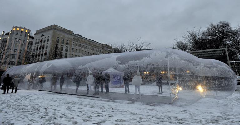 People walk inside an 82-foot condom during an AIDS awareness event marking the World AIDS Day in Budapest, Hungary, Wednesday.
