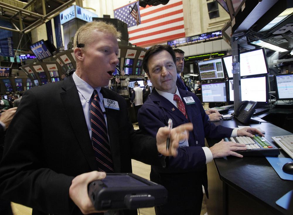 Trader Brian Dolan, left, works with specialist Thomas Facchine on the floor of the New York Stock Exchange. (AP)